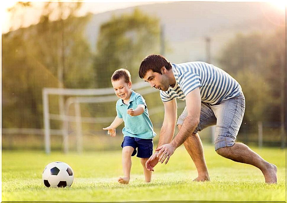 A father and his son playing football