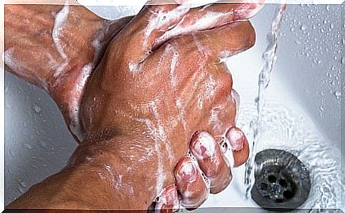 man washing his hands with liquid soap