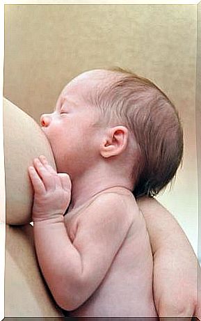 A baby sucking on his mother's breast. 